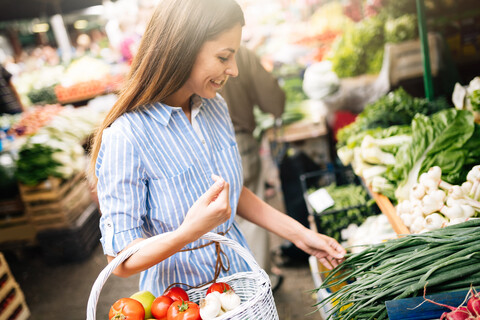 Picture of woman at marketplace buying vegetables